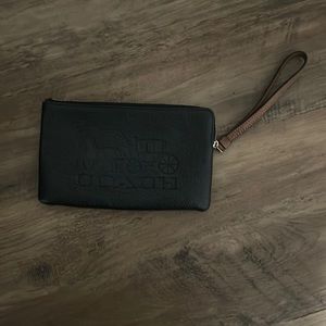Black wristlet with tan handle. Real leather